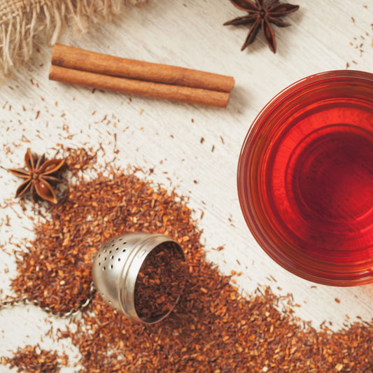 CINNAMON BUN ROOIBOS CHAI, spices and a tea cup filled with tea. Queen of Cups Tea Company. 